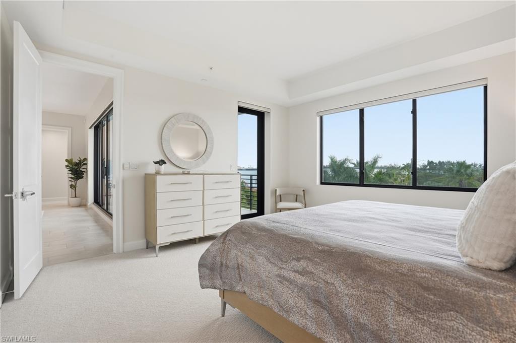 Bedroom with access to outside and light colored carpet