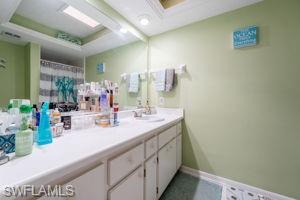 Bathroom featuring curtained shower and vanity
