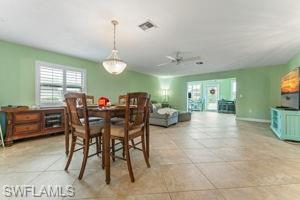 Dining space with ceiling fan and baseboards