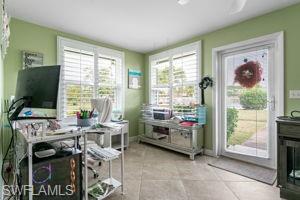Home office / den with light tile patterned floors