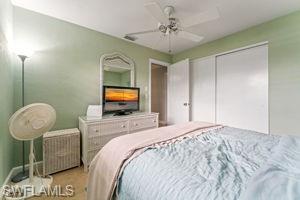Bedroom featuring ceiling fan and a closet