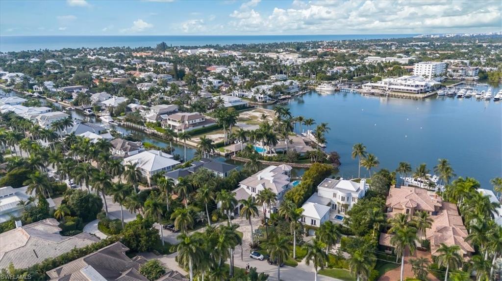 Aerial overview of property's location featuring a nearby body of water and nearby suburban area
