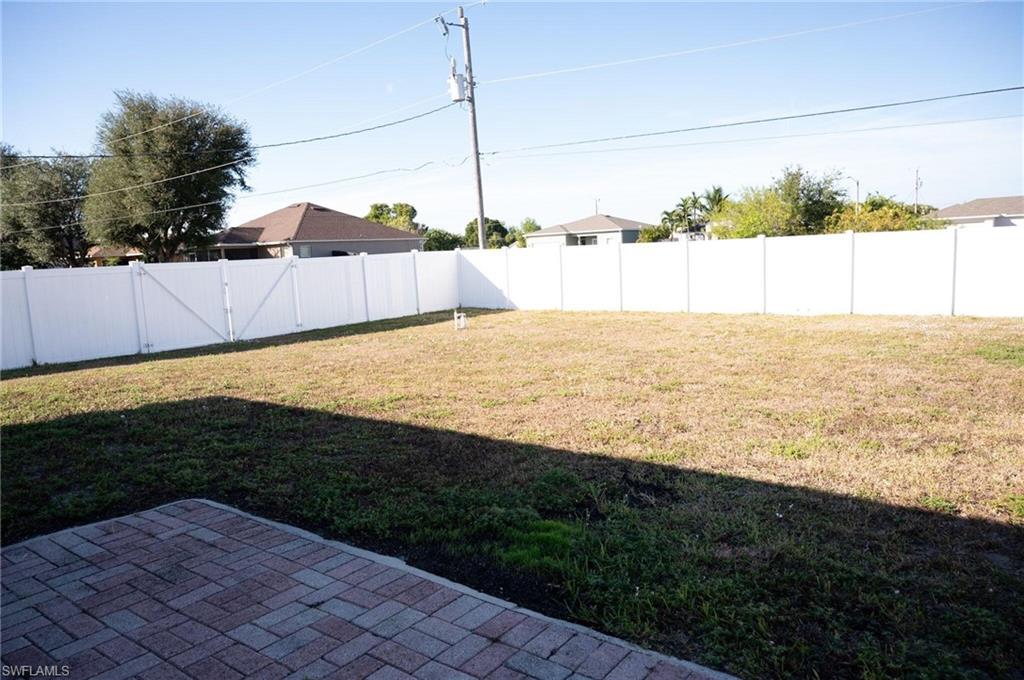Fenced backyard featuring a patio