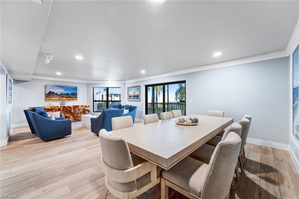 Community room featuring ornamental molding, light wood-type flooring, and recessed lighting