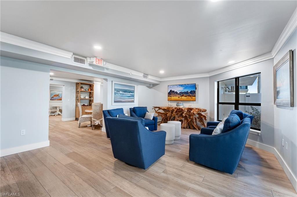 Community area with light wood-style flooring, crown molding, and recessed lighting