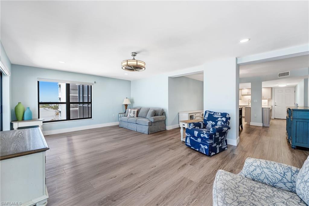 Huge Living area with recessed lighting and light wood-type flooring