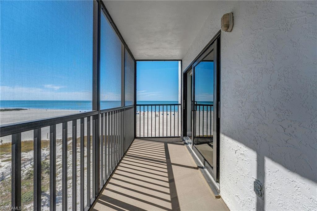 Balcony of the Master bedroom featuring view of water and beach