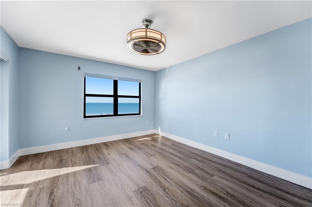 Large Master bedroom  room featuring baseboards and wood finished floors