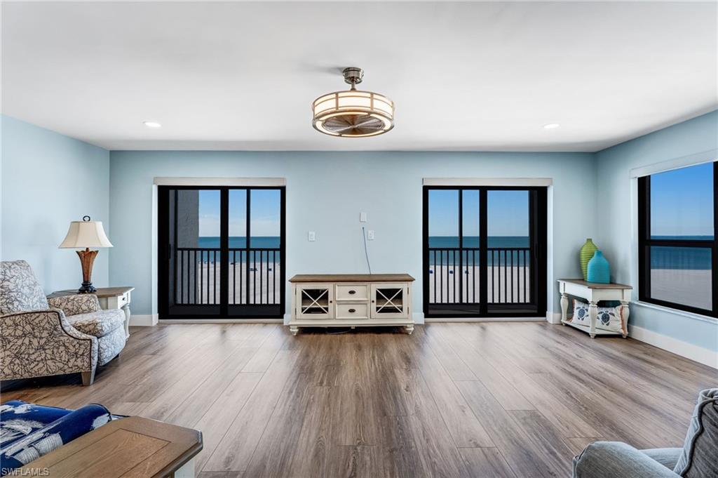 Can't get enough of these views!!  Living area featuring recessed lighting, a water view, and wood finished floors