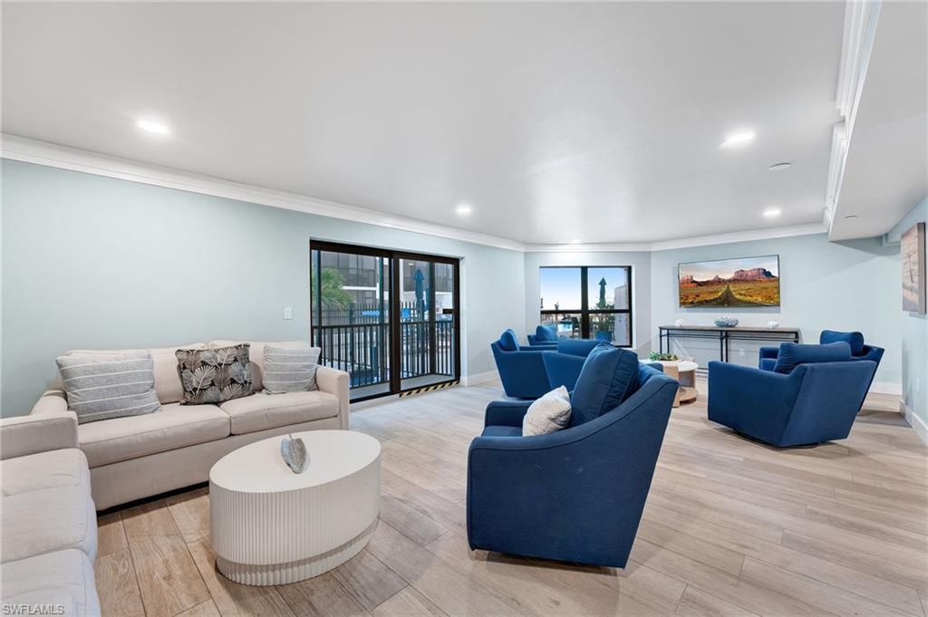 Community Living area with light wood-style flooring, ornamental molding, and recessed lighting