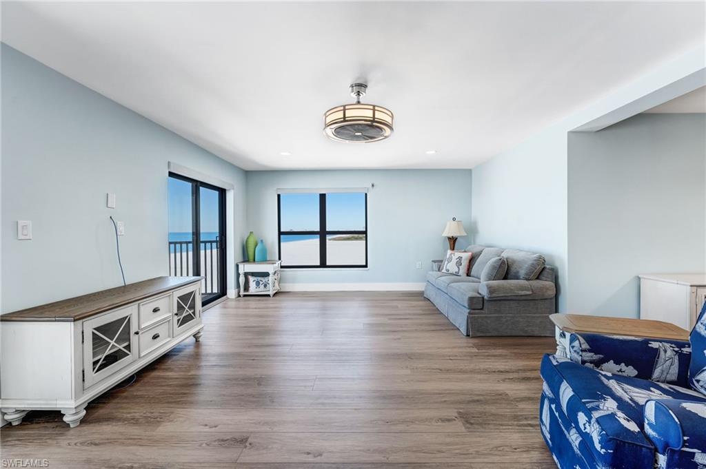 Every window has a view!  Living area with light wood-type flooring and baseboards