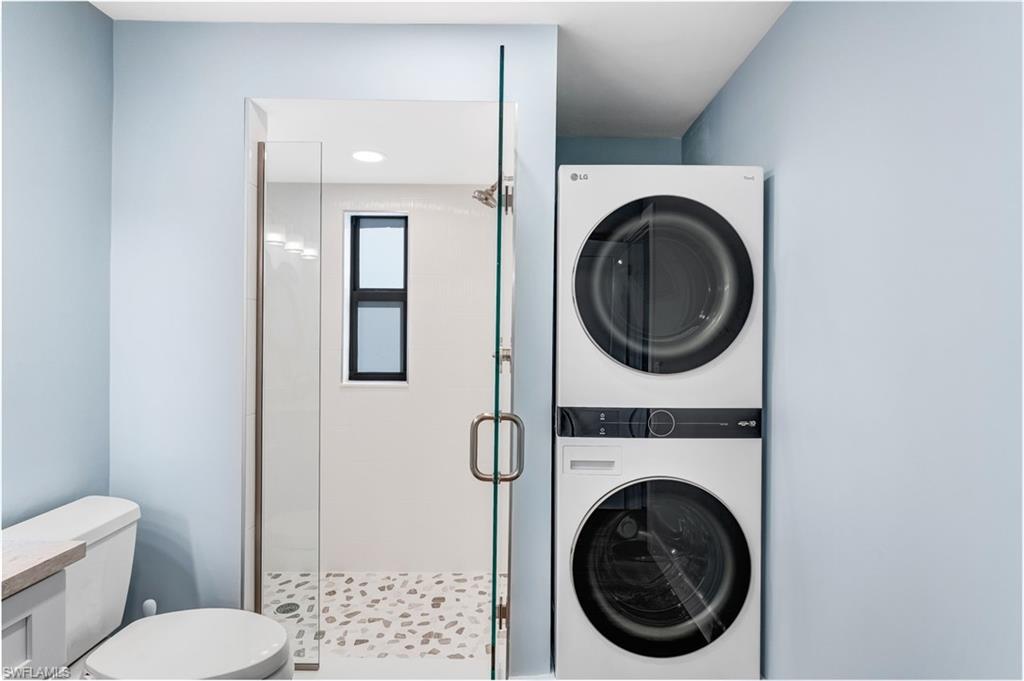 Washroom with stacked washer / drying machine