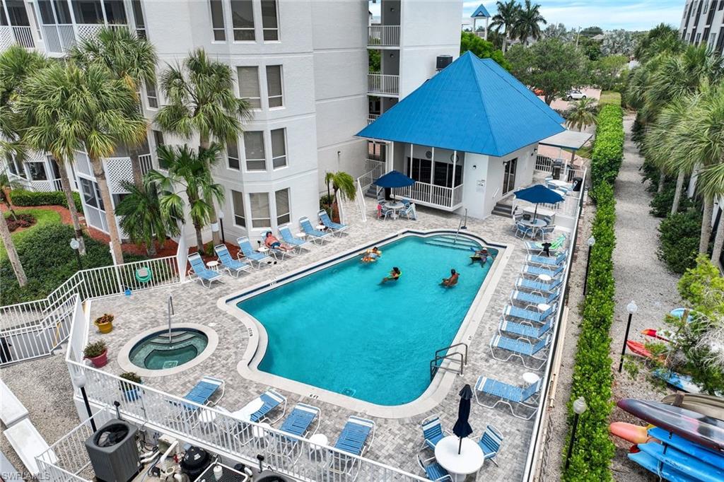 Community pool featuring a hot tub and a patio