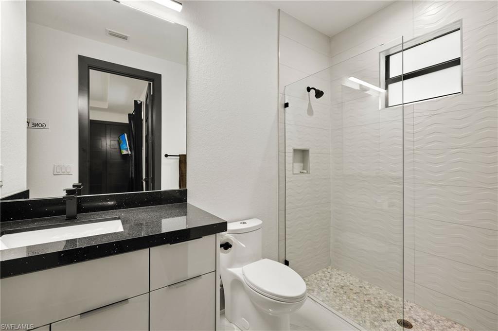 Full bathroom with walk in shower and vanity
