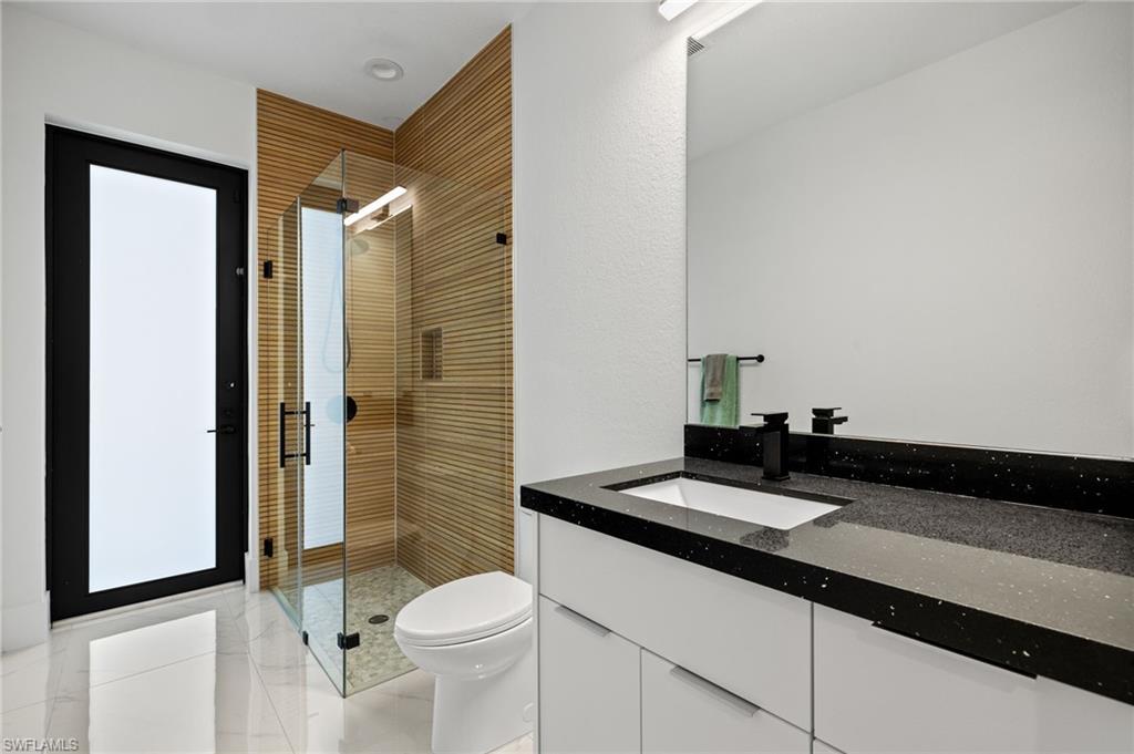 Full bath with a stall shower and vanity
