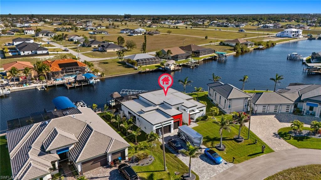 Aerial view of residential area featuring a large body of water