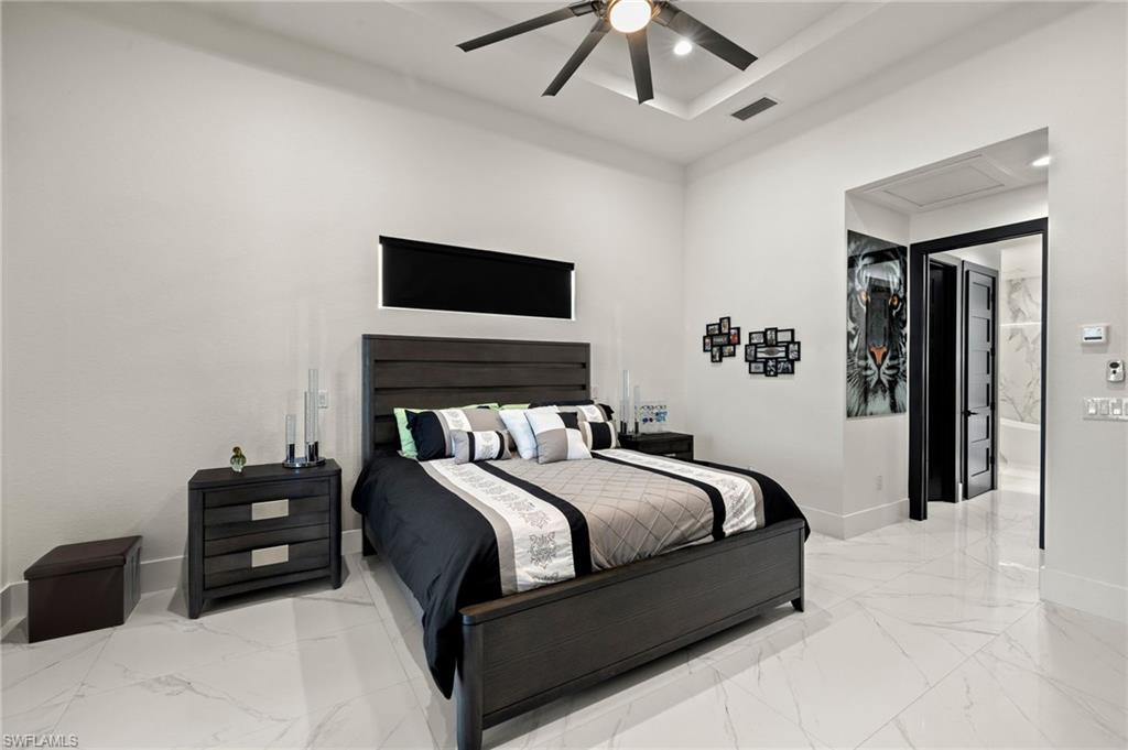 Bedroom featuring light marble finish flooring, recessed lighting, attic access, and a ceiling fan