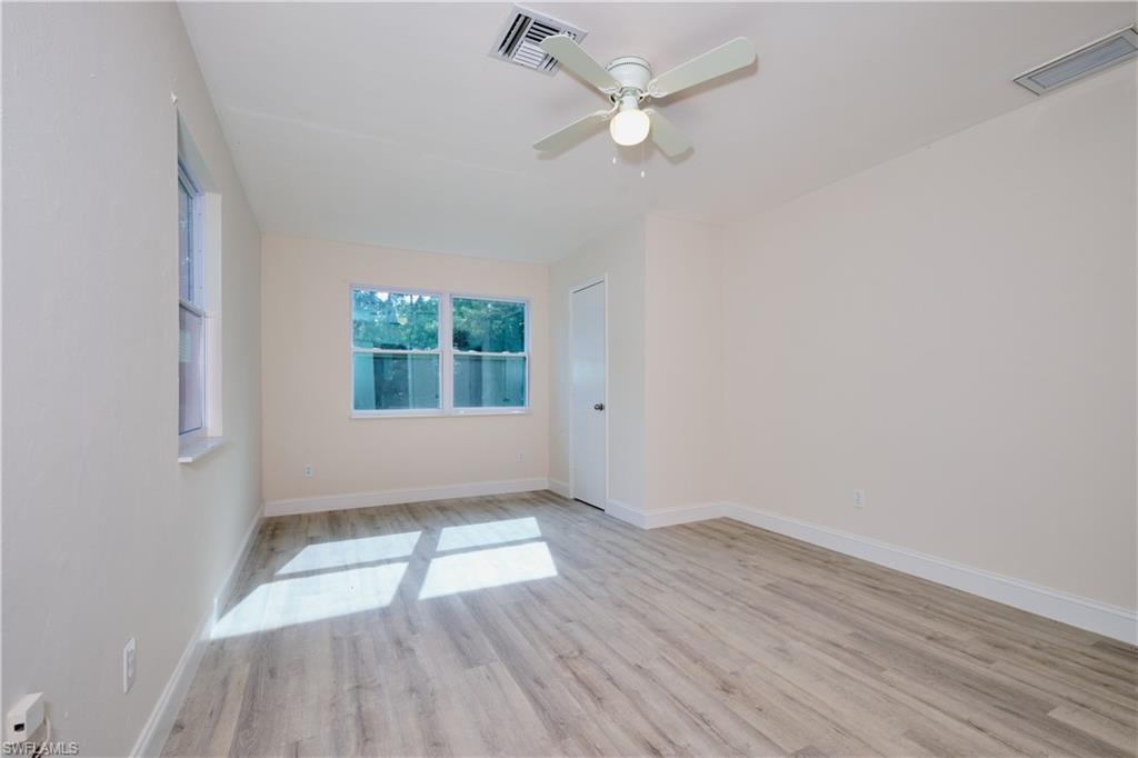 Empty room featuring light wood-style floors and ceiling fan