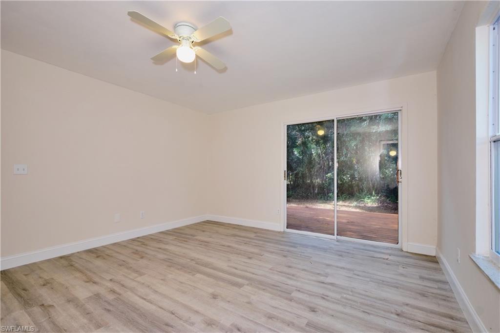 Empty room featuring light wood-type flooring and a ceiling fan