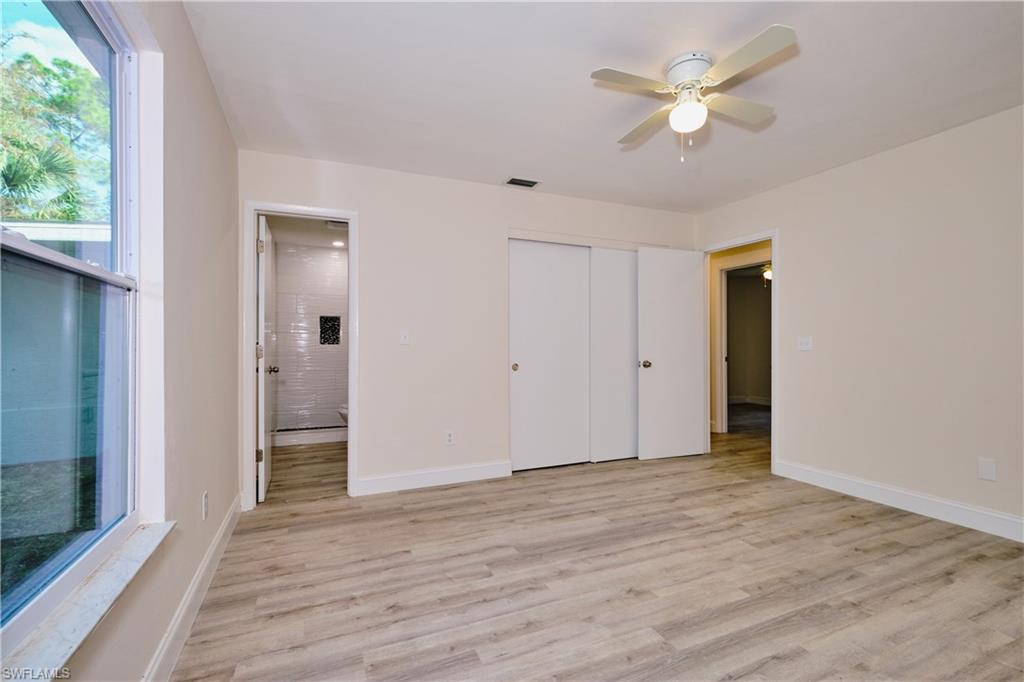 Unfurnished bedroom with light wood-type flooring, ceiling fan, and a closet