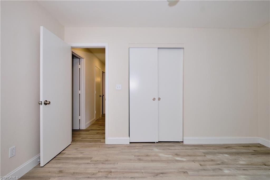 Unfurnished bedroom featuring light wood-style flooring and a closet