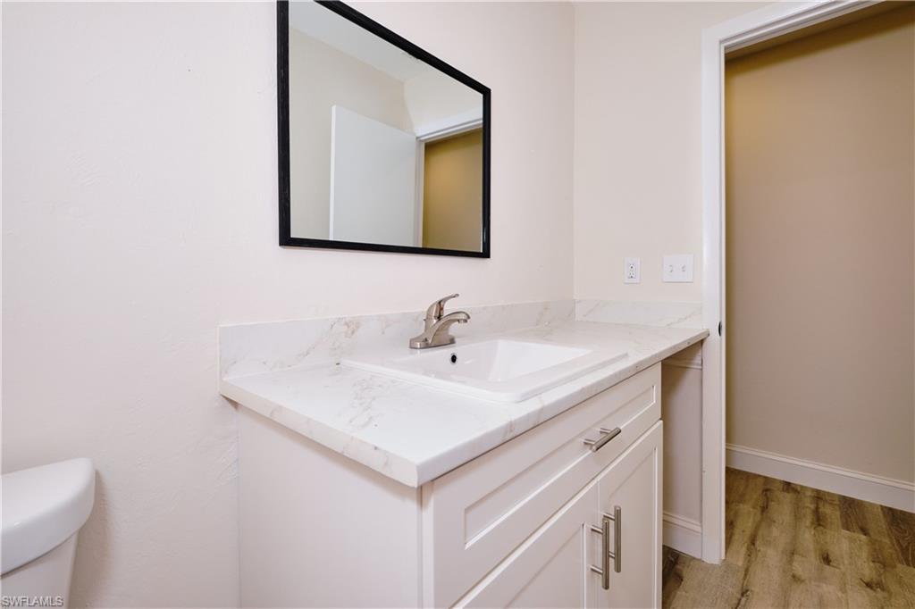 Bathroom featuring vanity and light wood finished floors