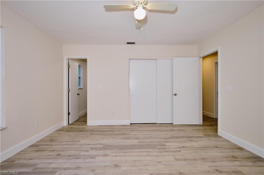 Unfurnished bedroom featuring light wood-style flooring, a ceiling fan, and a closet