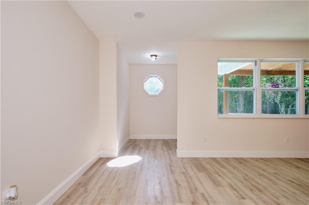 Empty room featuring baseboards and light wood-style floors