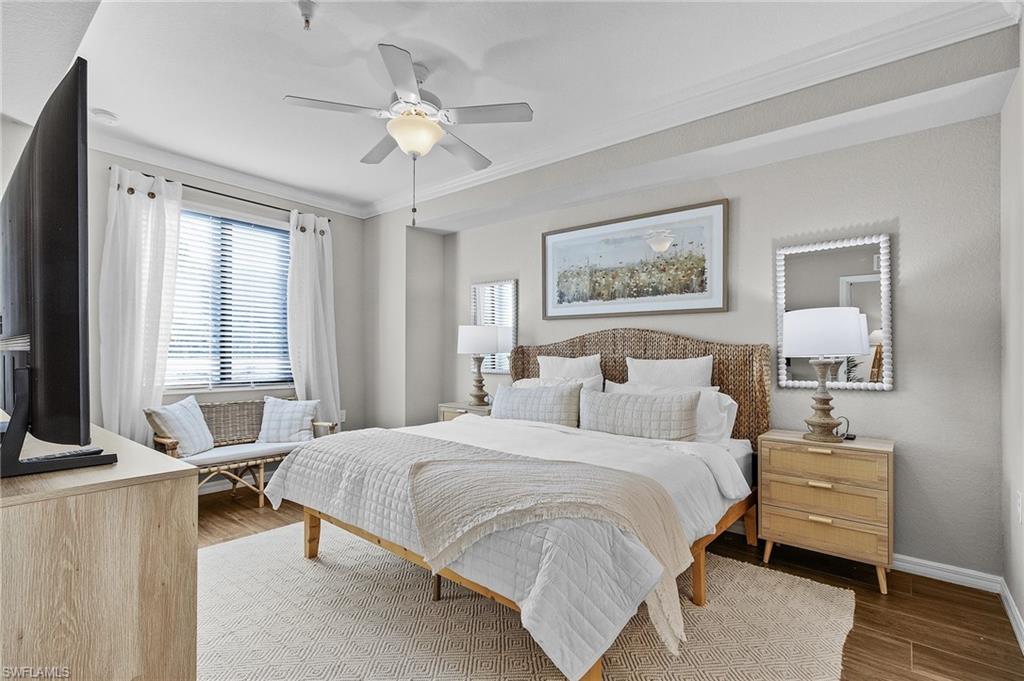 Bedroom featuring ceiling fan, ornamental molding, and hardwood / wood-style flooring