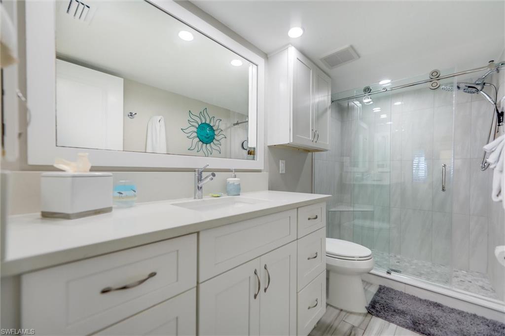 Full bathroom featuring vanity, a stall shower, and recessed lighting
