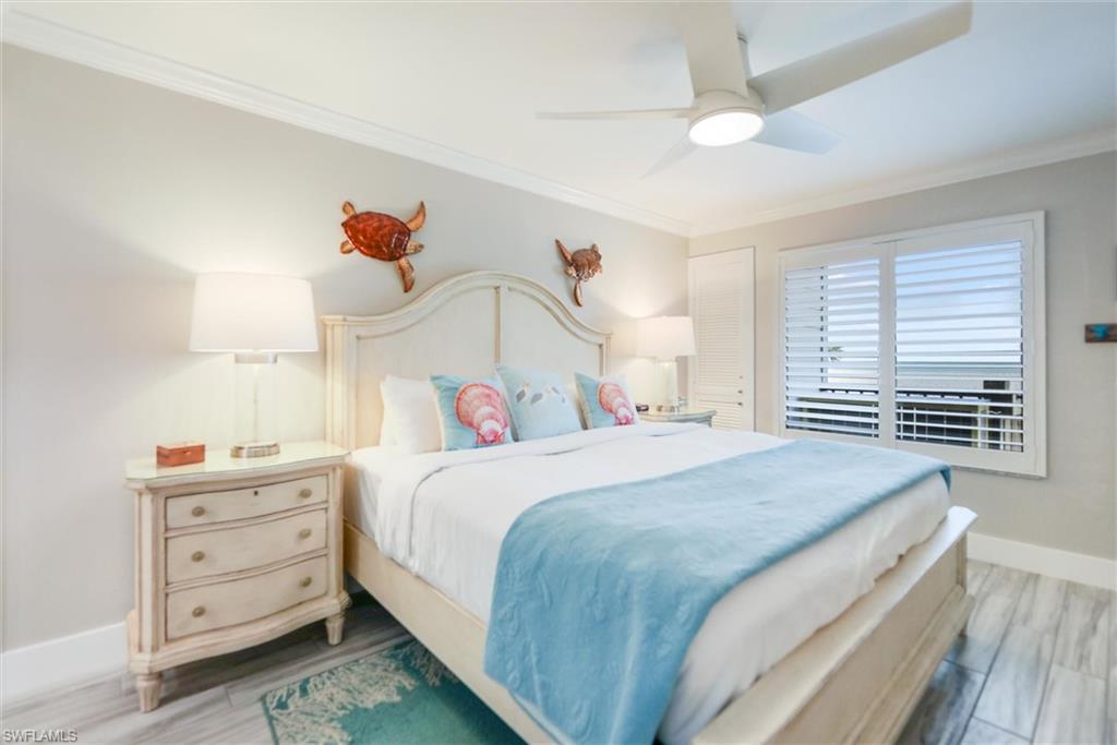 Bedroom with crown molding, a ceiling fan, and light wood finished floors
