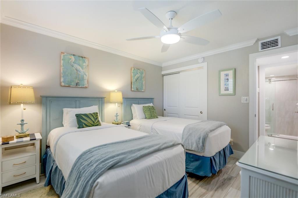 Bedroom featuring ornamental molding, a closet, a ceiling fan, and light wood finished floors