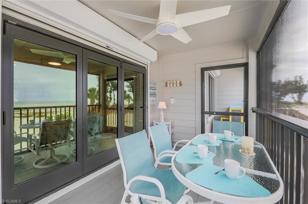 Sunroom / solarium with a ceiling fan, outdoor dining area, and french doors