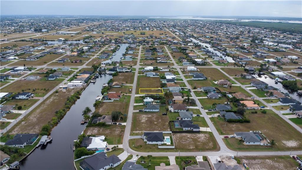 Aerial view of property's location with nearby suburban area and a large body of water