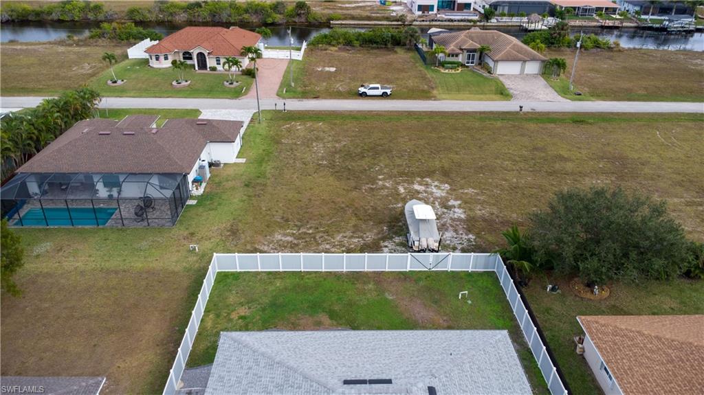Aerial perspective of suburban area featuring a large body of water