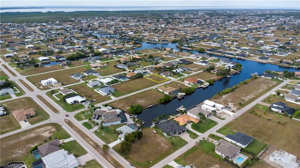 Aerial view of property's location featuring nearby suburban area and a nearby body of water