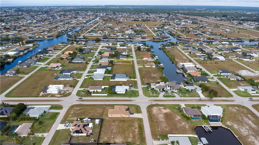 Aerial overview of property's location with nearby suburban area and a large body of water