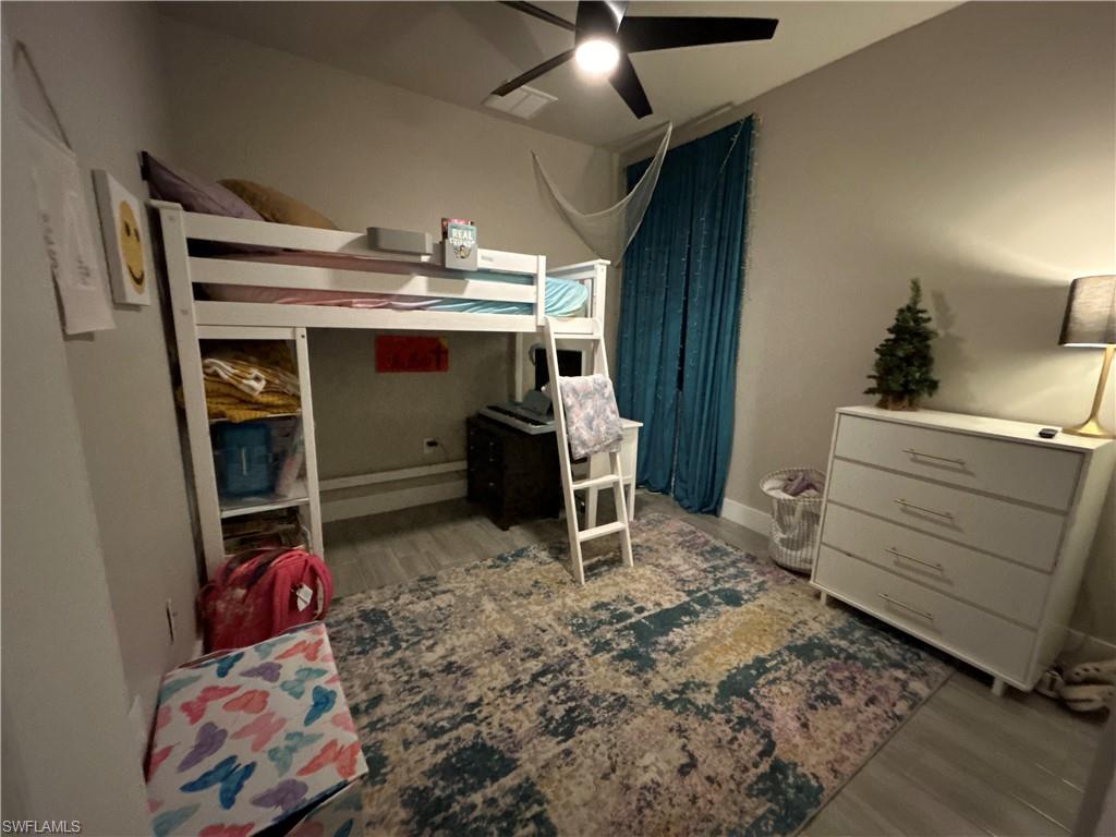 Bedroom featuring light wood finished looking floors and a ceiling fan