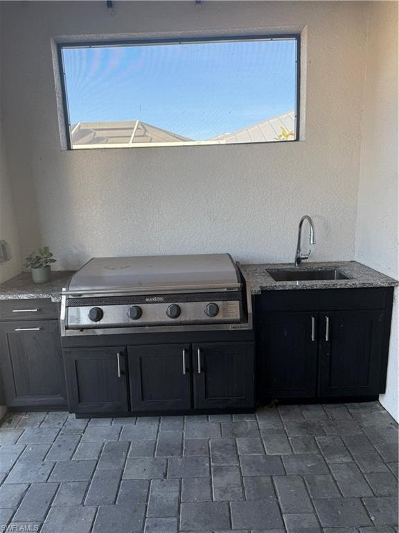 View of patio / terrace featuring area for grilling and a sink