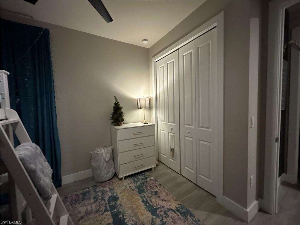 Bedroom featuring a closet, wood finished looking floors, and a ceiling fan
