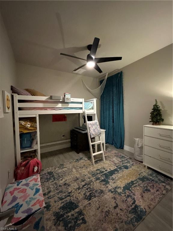 Bedroom with a ceiling fan and wood finished looking floors