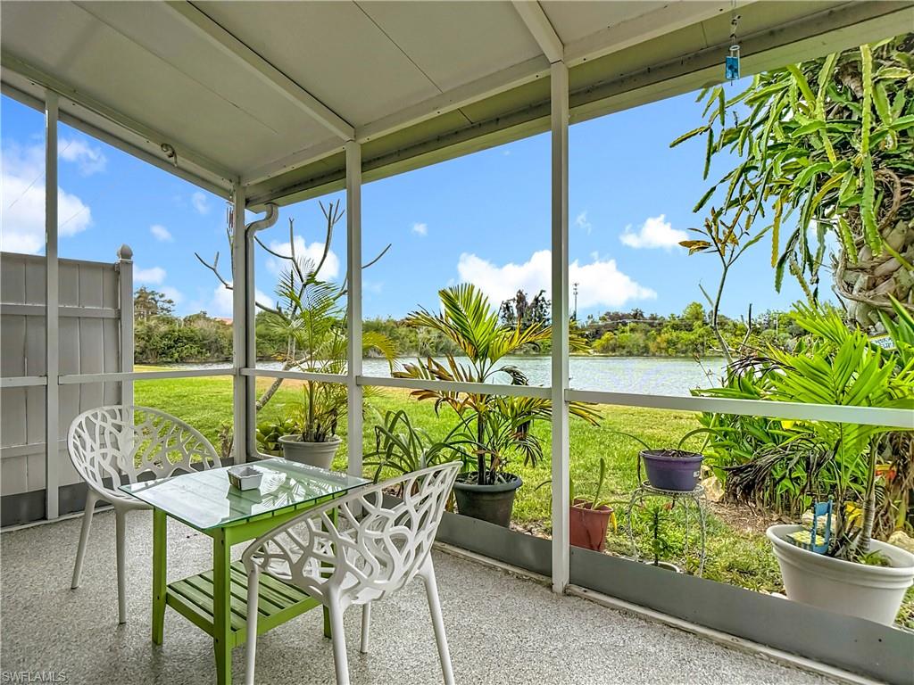 Sunroom / solarium featuring floor to ceiling windows, healthy amount of natural light, and a water view