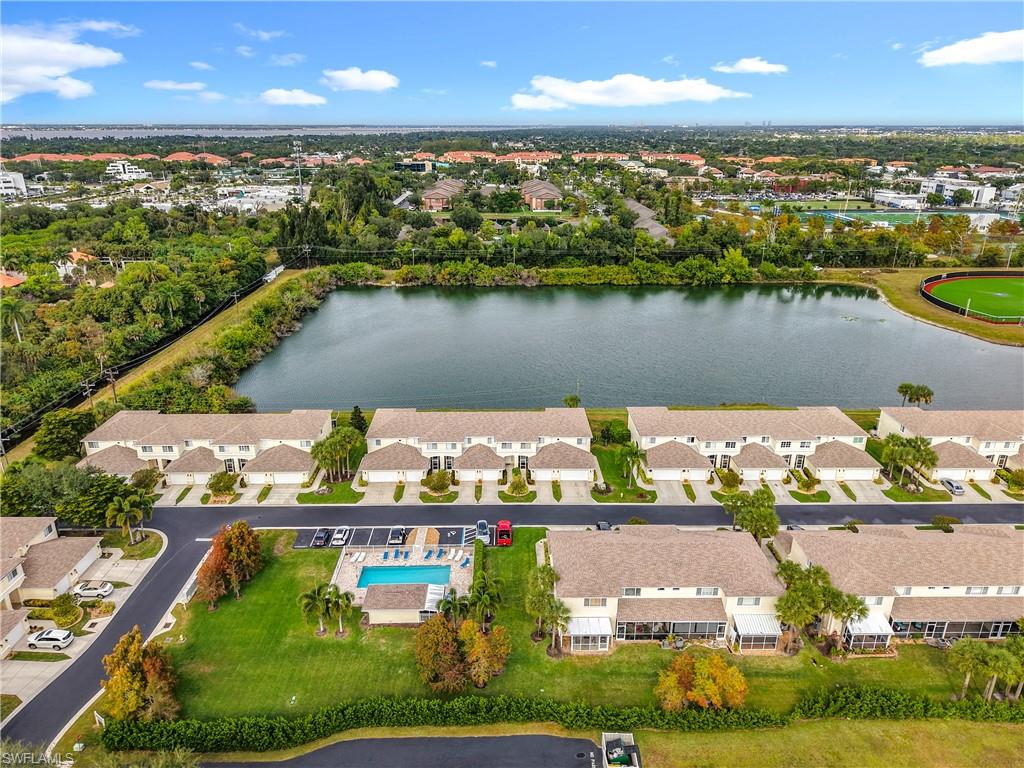 Aerial view of property's location with a large body of water and nearby suburban area