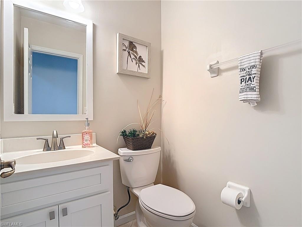 Half bathroom with vanity and toilet