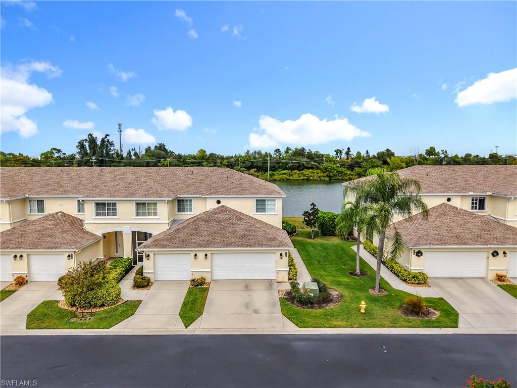 Traditional home with concrete driveway, stucco siding, a front yard, and an attached garage