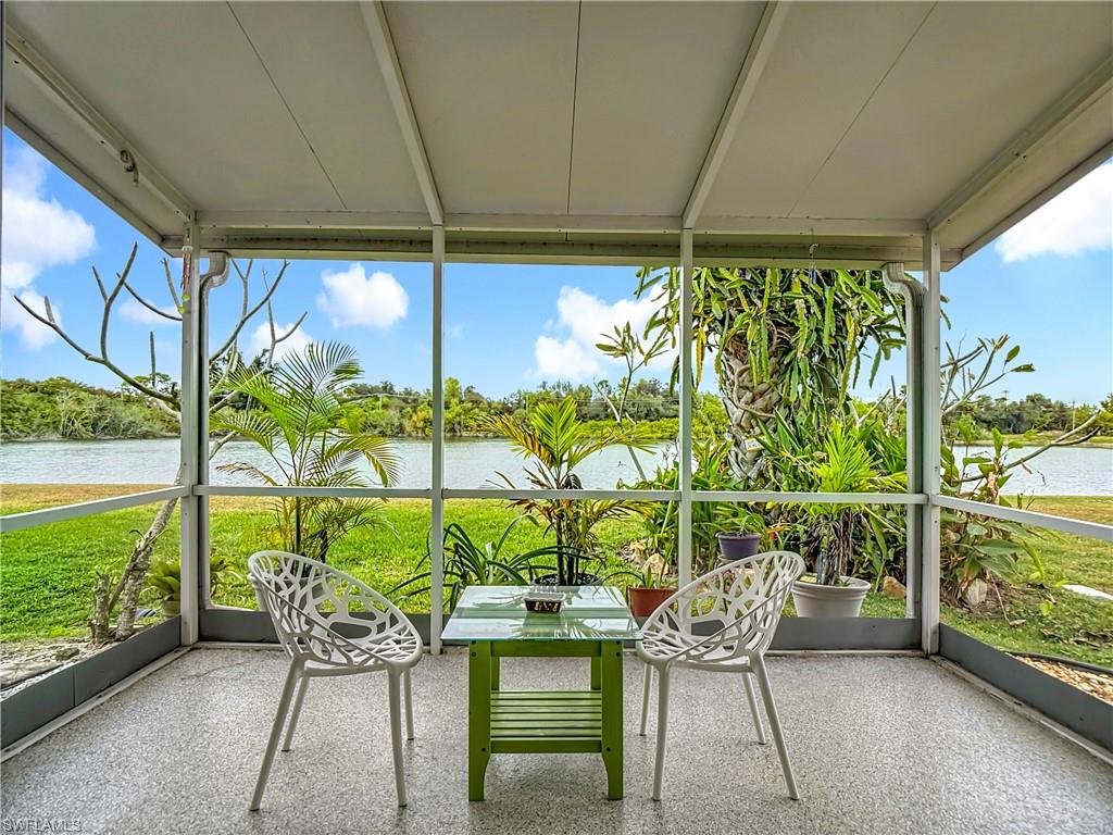 Unfurnished sunroom with expansive windows and a water view