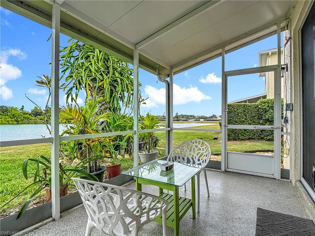 Sunroom featuring a water view