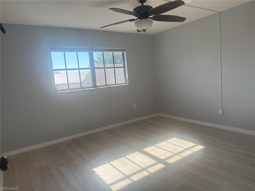 Spare room featuring light wood-style flooring and a ceiling fan