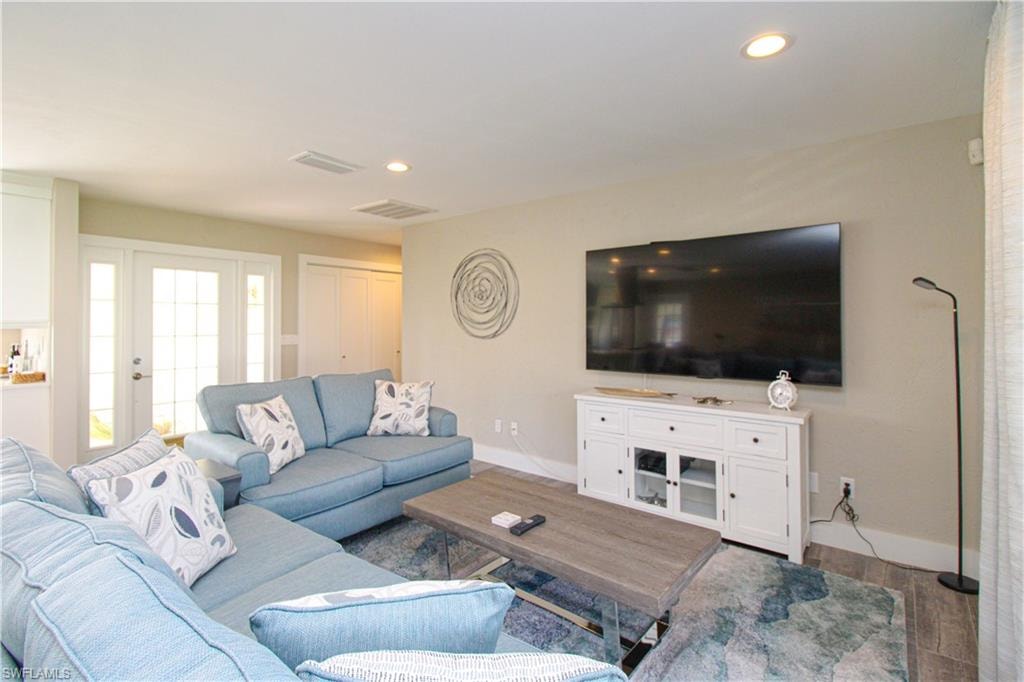 Living room with hardwood / wood-style flooring