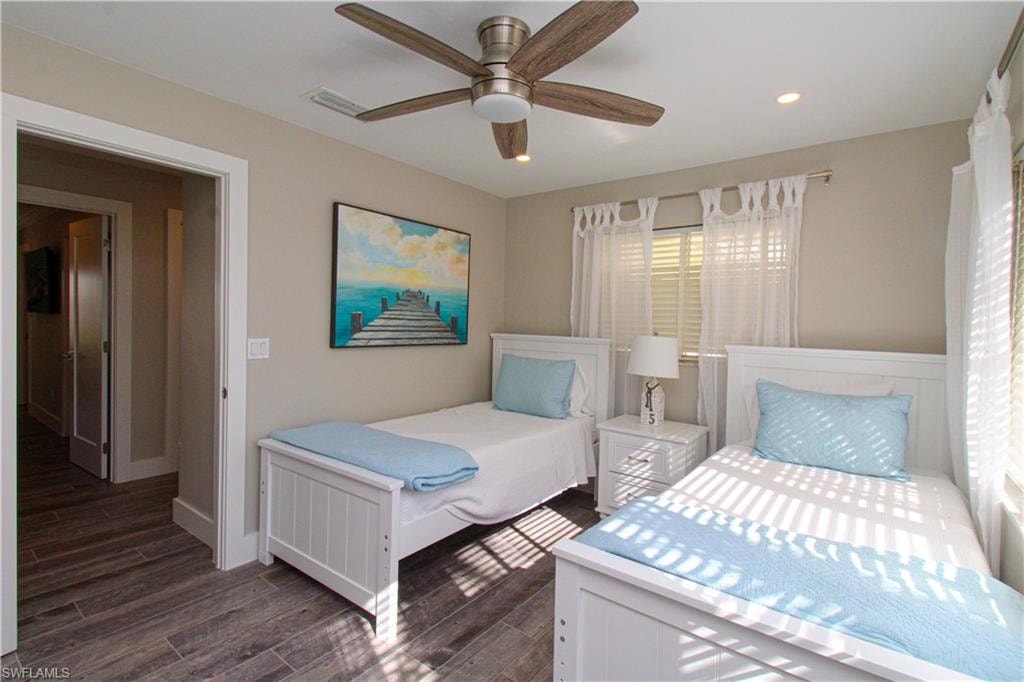 Bedroom featuring ceiling fan and dark hardwood / wood-style flooring